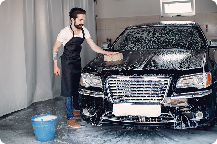 Hand washing a car with sponge